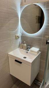 a bathroom with a sink and a mirror at Апартаменти GREEN центр вулиця Руська in Ternopil