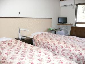 Postel nebo postele na pokoji v ubytování Hotel Famitic Myojin