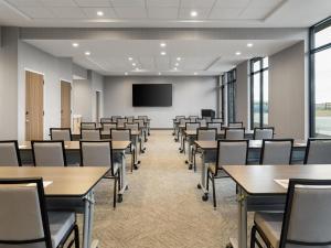 a conference room with tables and chairs and a screen at Hyatt Place Casper in Casper +38 photos