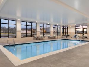 a large swimming pool in a building with windows at Hyatt Place Casper in Casper