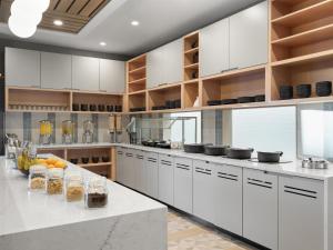 a kitchen with white cabinets and a white counter top at Hyatt Place Casper in Casper