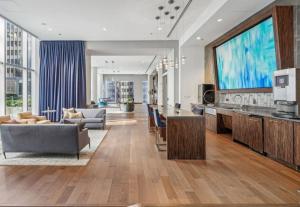 a living room with a large tv and a couch at Loop Studio w theater pool nr Millennium Park CHI-958 in Chicago