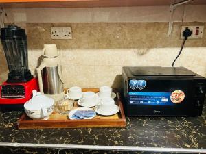 a kitchen counter with a coffee maker and a microwave at The Hidden Gem Near Central B&B in Nkunjila