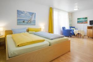a bedroom with a bed and a table and chairs at Apart Hotel Stadtgarten in Überlingen