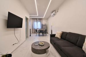 a living room with a couch and a table at Appartamento Delfino in Rimini