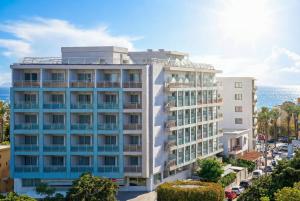 an apartment building with the ocean in the background at AQUAMARE CITY and BEACH in Rhodes Town