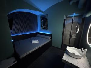 a bathroom with a bed and a sink and a shower at SPA SPA Petrská hostel in Prague