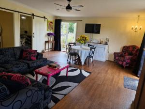 a living room with a couch and a table at Vibrant & Vintage B & B in Greenmount