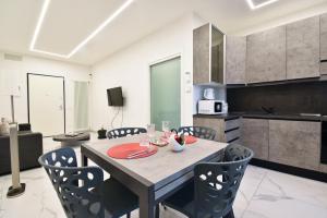a kitchen and dining room with a table and chairs at Appartamento Delfino in Rimini +2 photos