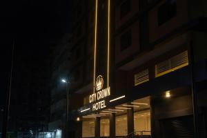 a hotel sign on the side of a building at night at City Crown Hotel in Dar es Salaam