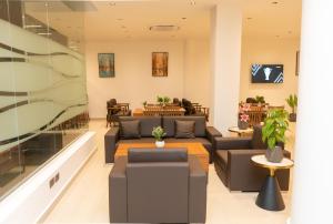 a lobby with couches and tables in a building at City Crown Hotel in Dar es Salaam