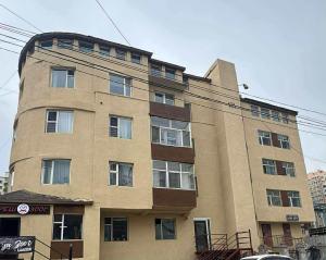 a tall brick building with a round top at Mini apartment in Central UB in Ulaanbaatar