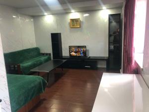 a living room with a couch and a table at Mini apartment in Central UB in Ulaanbaatar