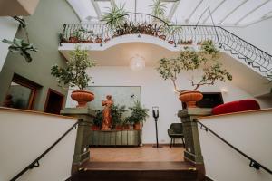 a hallway with a staircase with potted plants at Eco Friendly Hotel Dália in Košice
