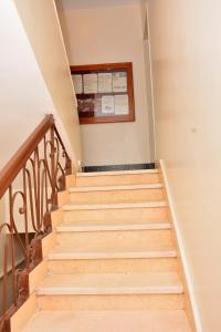 a set of stairs in a house with a sign on the wall at Fontana Luxor Hostel in Luxor