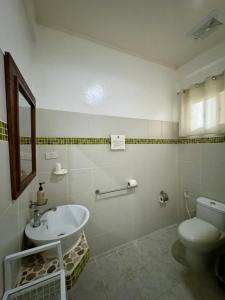 a bathroom with a sink and a toilet at La Natura Resort in Coron +24 photos