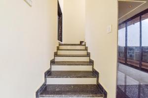 a staircase in a building with a window at FabHotel Blooming Beds Pearl in Jaipur