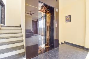 a hallway with a glass door and stairs at FabHotel Blooming Beds Pearl in Jaipur