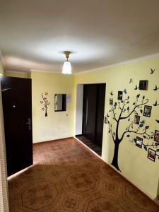 a hallway with a tree decal on the wall at Arpi-Ureni Guesthouse in Ertich