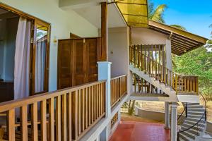 a house with a staircase leading to the front door at Jackhill Hiriketiya in Dickwella