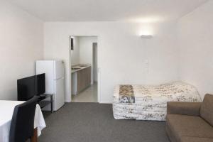 a hotel room with a bed and a couch at Ascot On Fenton in Rotorua