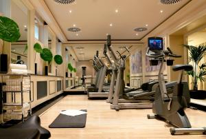 a gym with treadmills and elliptical machines at Hotel Sacher Wien in Vienna