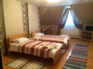 En eller flere senge i et værelse på Hotel Svitlytsia