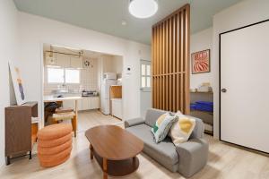a living room with a couch and a table at Cozy Retreat LATTE in Yatomi 