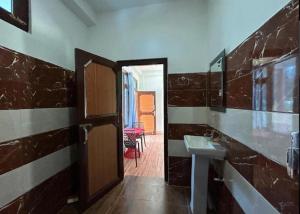 a bathroom with a sink and a mirror at Majestic House , Kalga , Kalgha in Kalgha