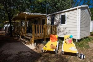 two chairs with a teddy bear sitting on them in front of a house at Lodge in Joyeuse
