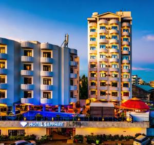 a hotel with a large building in front of it at Hotel Sapphire in Mombasa