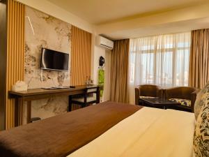 a hotel room with a bed and a desk at Hotel Sapphire in Mombasa