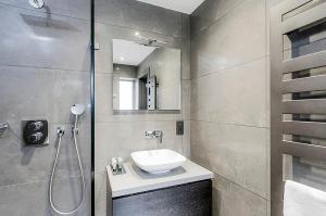 a bathroom with a sink and a shower at Hotel Agenda Louise in Brussels +38 photos