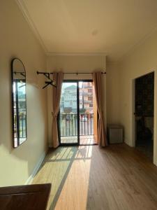 an empty living room with a door to a balcony at Natcha Hotel and Residence in Sathani Chumphon +10 photos