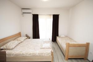 a bedroom with a bed and a window at Apartments KA-7 in Podgorica