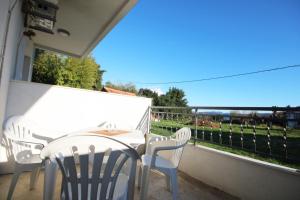 a white table and chairs on a balcony at Apartments KA-7 in Podgorica +17 photos