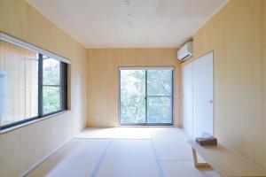 an empty room with a large window and a bench at SEN RETREAT TAKAHARA - Kumano Kodo Gateway in Chikatsuyu