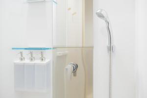 a shower with a shower head in a bathroom at SEN RETREAT TAKAHARA - Kumano Kodo Gateway in Chikatsuyu +47 photos
