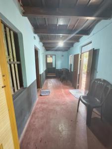 an empty hallway with a chair in a room at RR Homestay in Nīleswaram