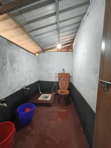 a bathroom with a toilet in a room at RR Homestay in Nīleswaram