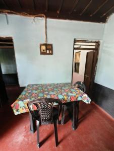 a table and a chair in a room at RR Homestay in Nīleswaram