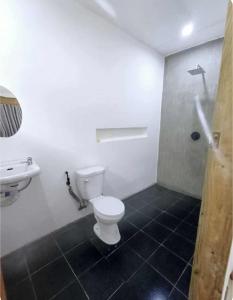 a bathroom with a toilet and a sink at Ayu Homestay in San Isidro