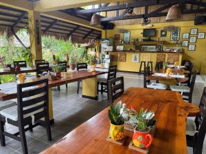 a restaurant with wooden tables and chairs in a room at La Natura Resort in Coron