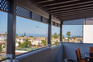 a balcony with a view of a city at The Blue Mile w Jacuzzi in Paralimni