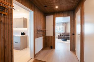 an open hallway with a kitchen and a living room at Lapland Lakeside Villa in Ranua