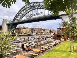 a bridge over a river with people sitting at tables at Hilton Newcastle Tyne Bridge in Newcastle upon Tyne