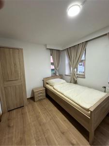a bedroom with a large bed and a window at Gästehaus Anker in Dinkelsbühl