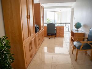 an office with a hallway with a desk and a chair at Oniro Guest House in Bedfordview +25 photos