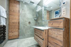 a bathroom with a shower and a sink at AlpenLiving in Mayrhofen +50 photos