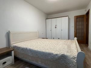 a bedroom with a large bed and a closet at Cietokšņa 64 in Daugavpils +3 photos